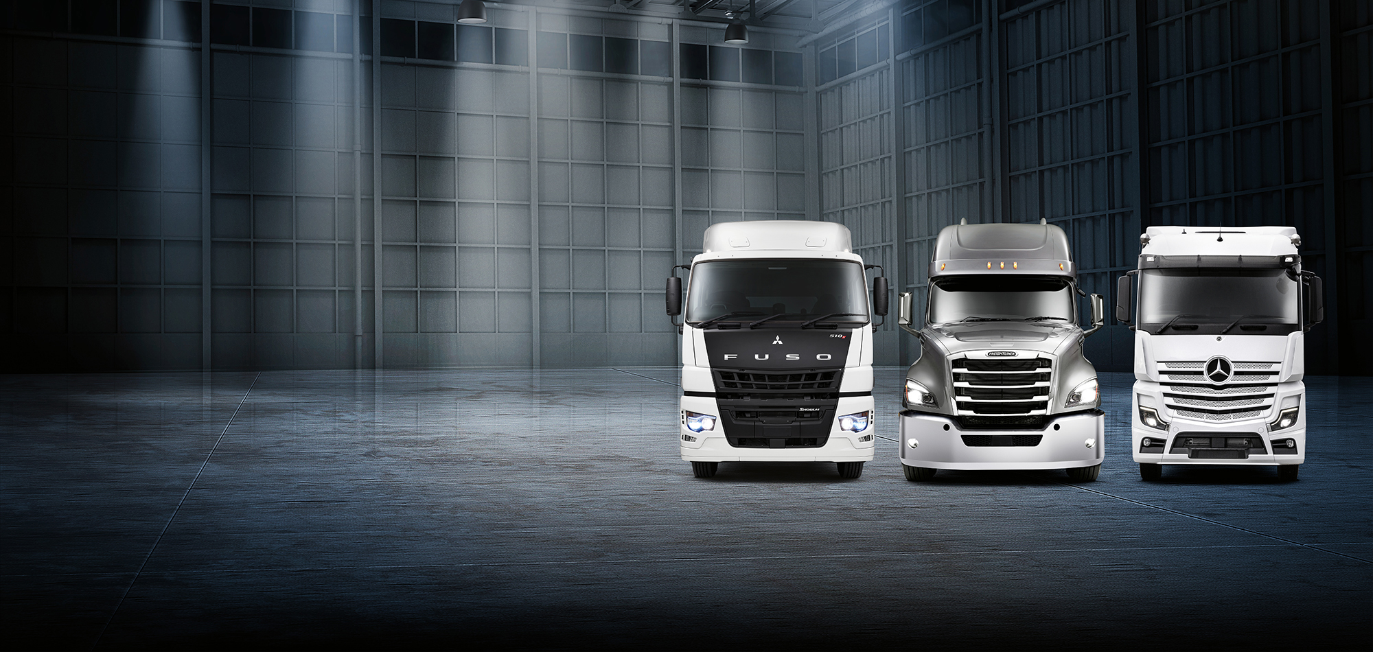 A Fuso, Freightliner and Mercedes-Benz truck under stage lighting