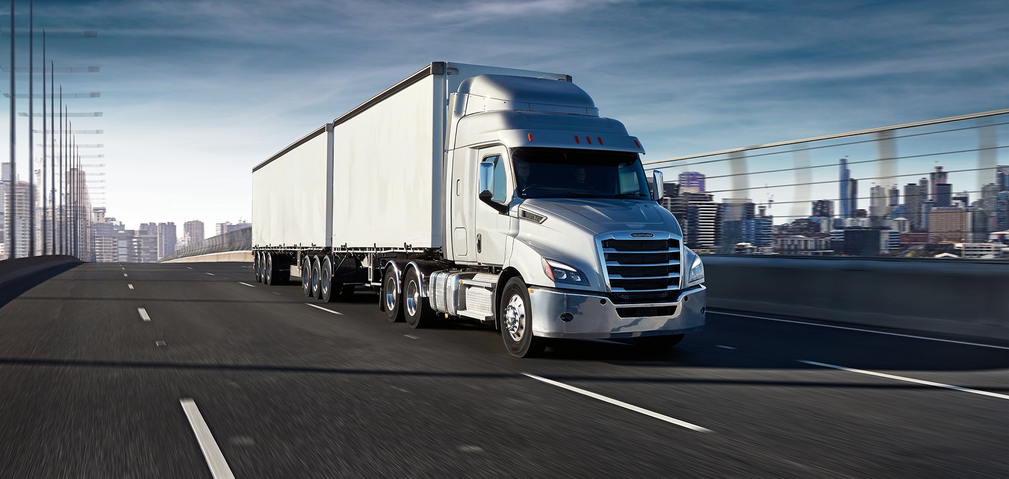 Freightliner truck featured driving on the highway